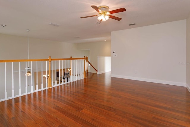 unfurnished room with ceiling fan and dark hardwood / wood-style flooring