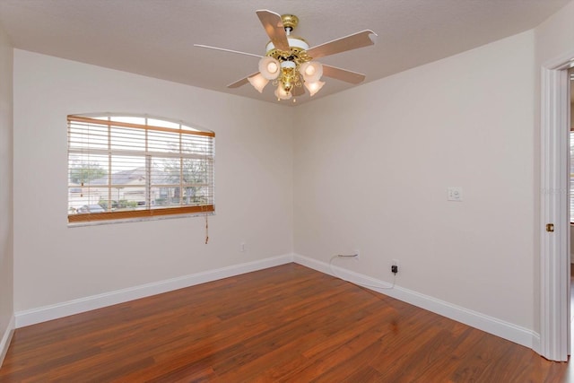 spare room with hardwood / wood-style flooring and ceiling fan