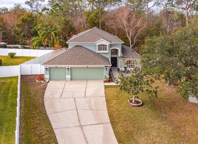 front facade featuring a garage and a front lawn