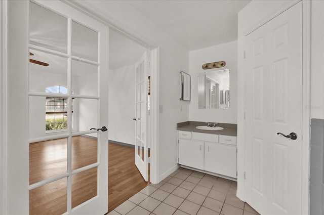 bathroom featuring french doors, tile patterned floors, and vanity