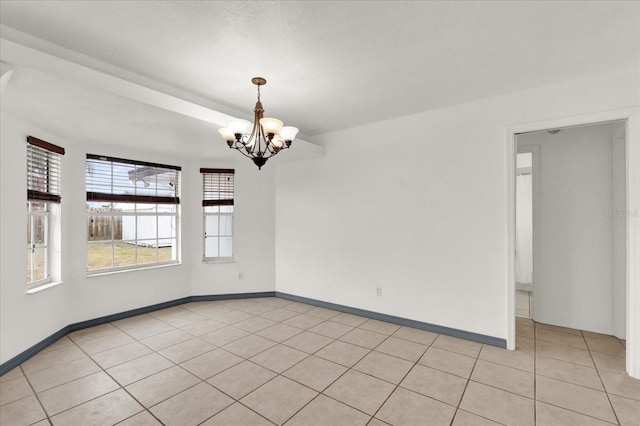 tiled empty room with a chandelier