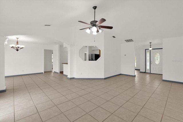 unfurnished living room with light tile patterned flooring and ceiling fan with notable chandelier