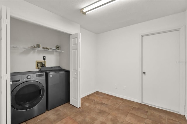 laundry area featuring washing machine and clothes dryer