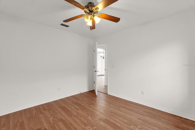 spare room featuring hardwood / wood-style flooring and ceiling fan