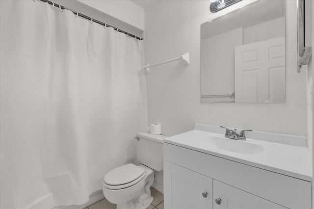 bathroom featuring walk in shower, vanity, toilet, and tile patterned flooring