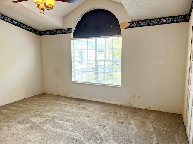 carpeted spare room with ceiling fan and a textured ceiling