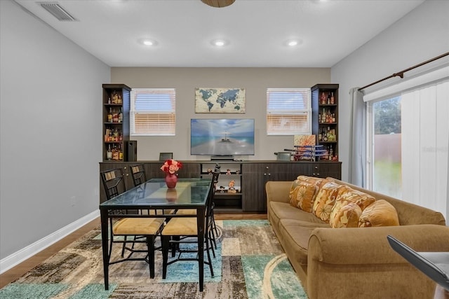 dining space with hardwood / wood-style flooring