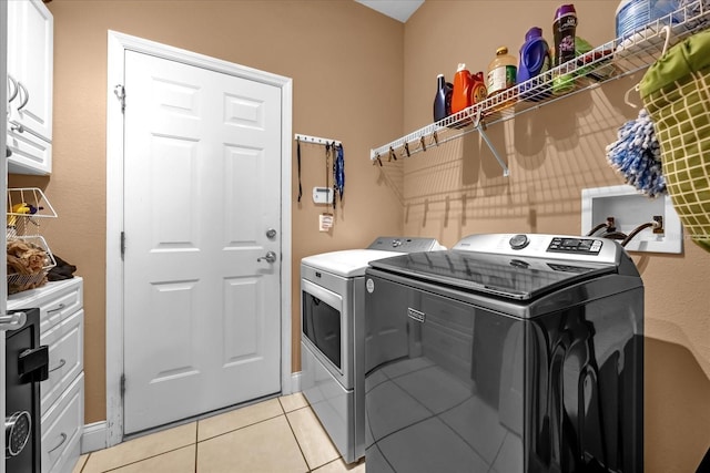 clothes washing area featuring independent washer and dryer and light tile patterned floors