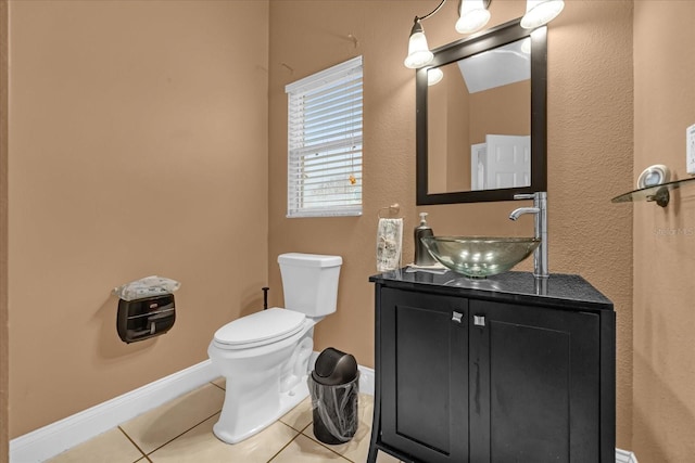 bathroom featuring vanity, tile patterned floors, and toilet