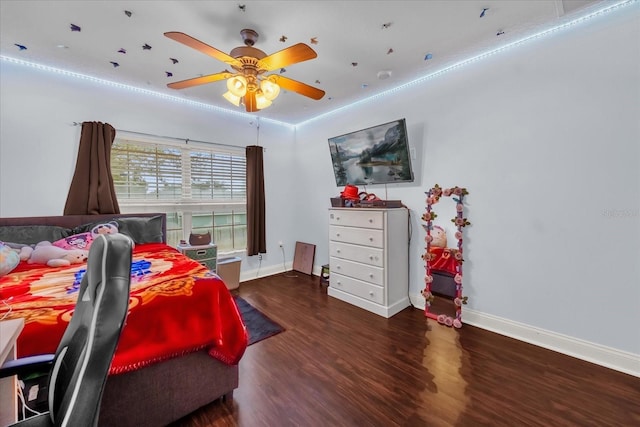 bedroom with ceiling fan and dark hardwood / wood-style flooring