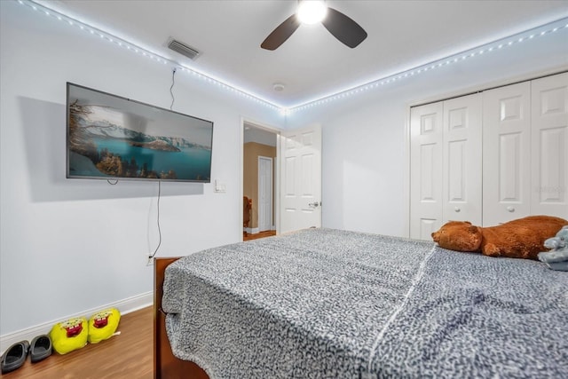 bedroom featuring wood-type flooring, a closet, and ceiling fan