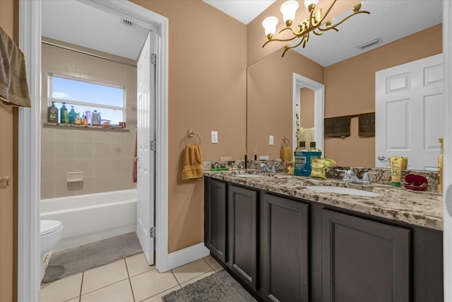 full bathroom featuring toilet, tiled shower / bath, vanity, a notable chandelier, and tile patterned flooring