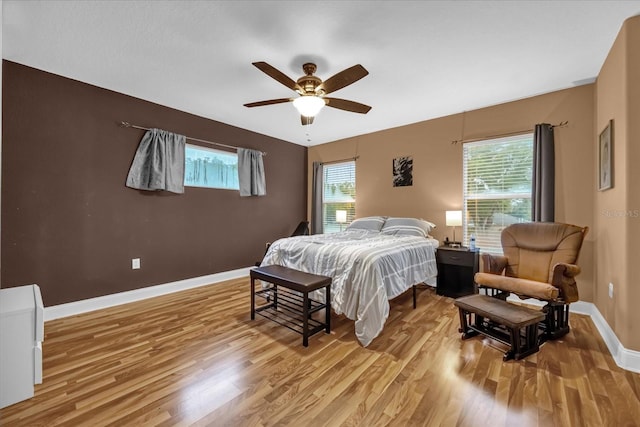 bedroom with ceiling fan and light hardwood / wood-style floors