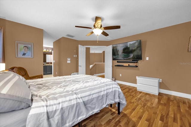 bedroom featuring wood-type flooring and ceiling fan