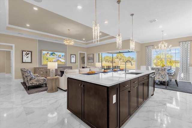 kitchen featuring decorative light fixtures, sink, and a raised ceiling