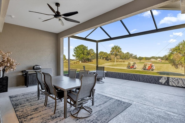 view of patio / terrace with ceiling fan and glass enclosure