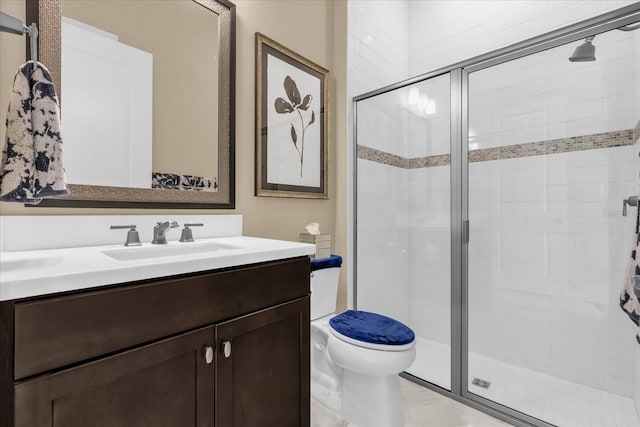 bathroom with vanity, toilet, and a shower with shower door