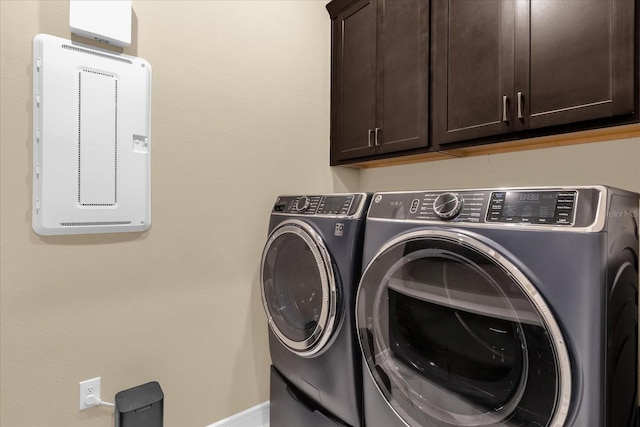 laundry room featuring cabinets and washer and dryer