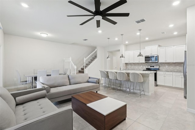 tiled living room featuring ceiling fan