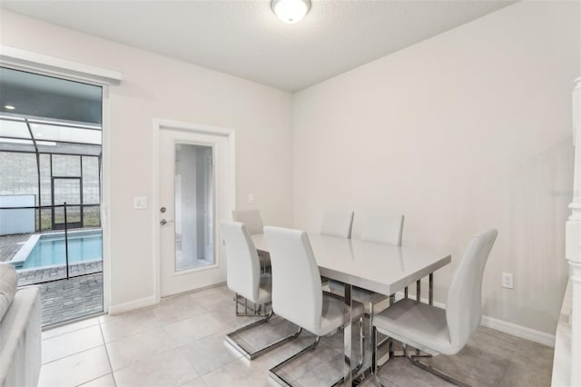 dining room featuring light tile patterned floors and a textured ceiling