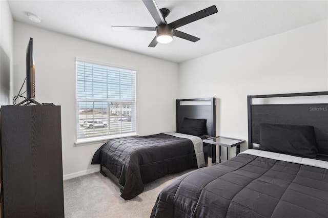 bedroom featuring ceiling fan and light carpet