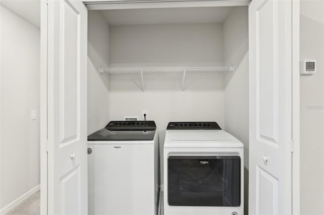 clothes washing area with independent washer and dryer and carpet