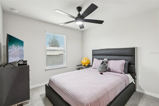 bedroom featuring ceiling fan and light carpet