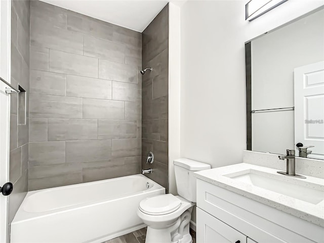 full bathroom featuring vanity, toilet, wood-type flooring, and tiled shower / bath combo