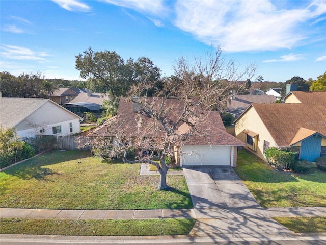 view of front of home with a front yard and a garage