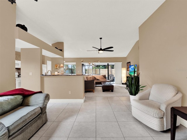 tiled living room featuring ceiling fan and lofted ceiling