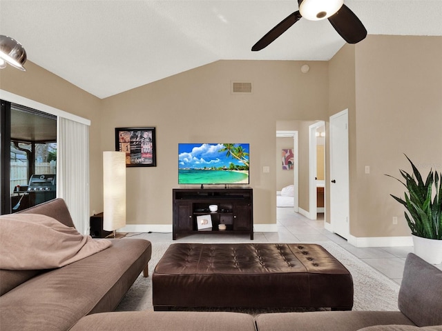 tiled living room featuring ceiling fan and lofted ceiling