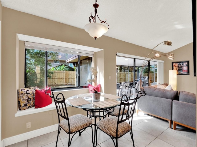 tiled dining space with a textured ceiling