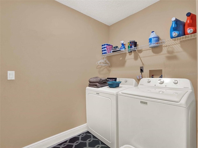 washroom featuring washer and dryer and a textured ceiling