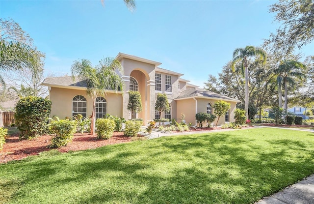 mediterranean / spanish-style home with a front yard