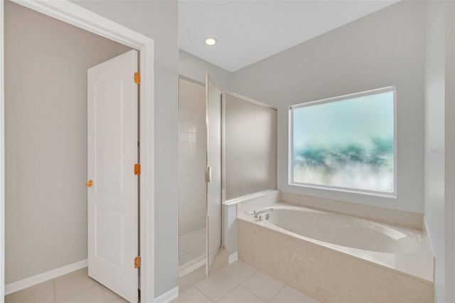 bathroom featuring tile patterned floors and separate shower and tub