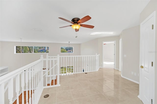 hall featuring light tile patterned floors