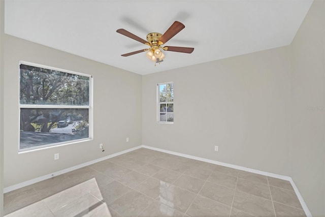 spare room featuring light tile patterned floors and ceiling fan