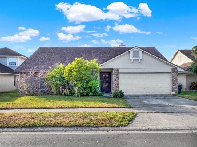 view of front of home with a garage and a front lawn