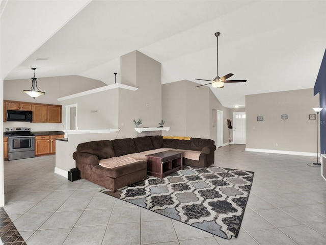 living room featuring vaulted ceiling, ceiling fan, and light tile patterned floors