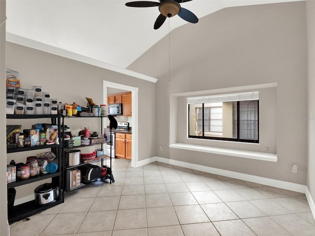 interior space with ceiling fan, vaulted ceiling, and ornamental molding