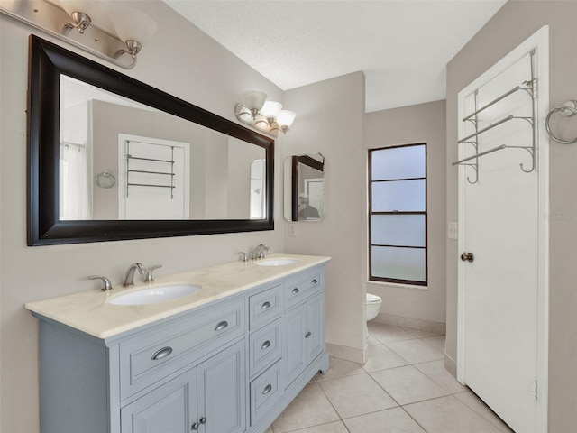 full bathroom with toilet, shower / washtub combination, tile patterned flooring, a textured ceiling, and vanity