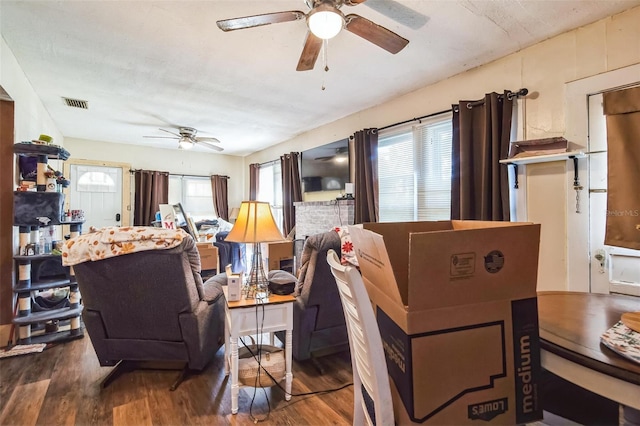 living room featuring ceiling fan and hardwood / wood-style flooring