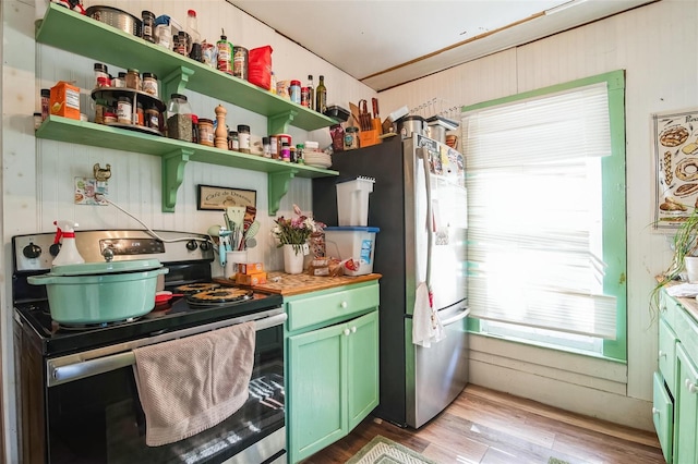 kitchen featuring stainless steel appliances and light hardwood / wood-style flooring