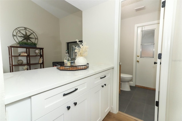 bathroom featuring tile patterned floors, toilet, and vanity