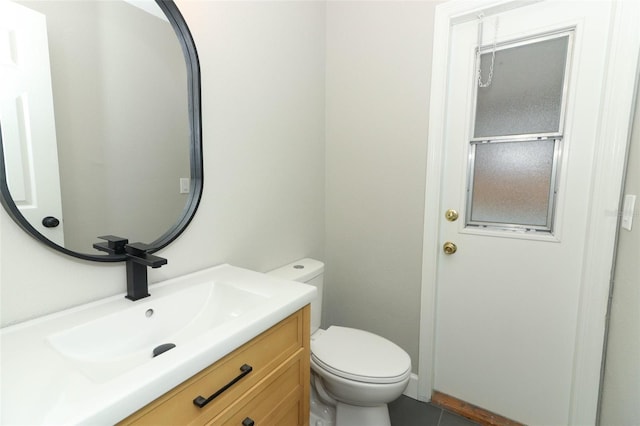 bathroom featuring vanity and toilet