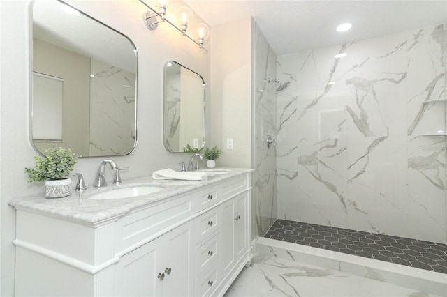 bathroom with vanity and tiled shower