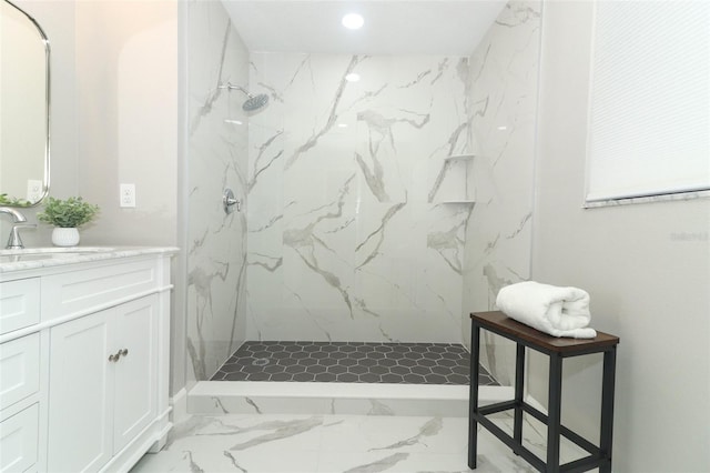 bathroom with vanity and a tile shower