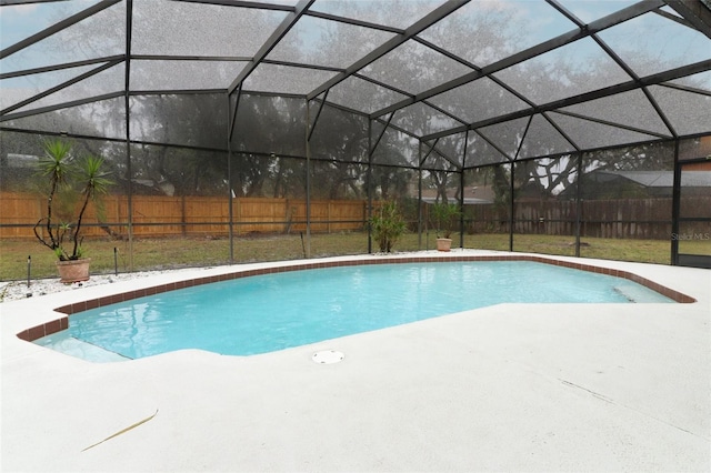 view of pool with a patio and glass enclosure