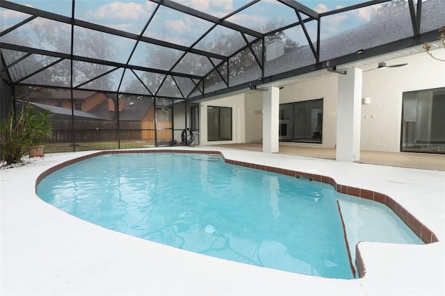 view of swimming pool with a lanai and a patio area