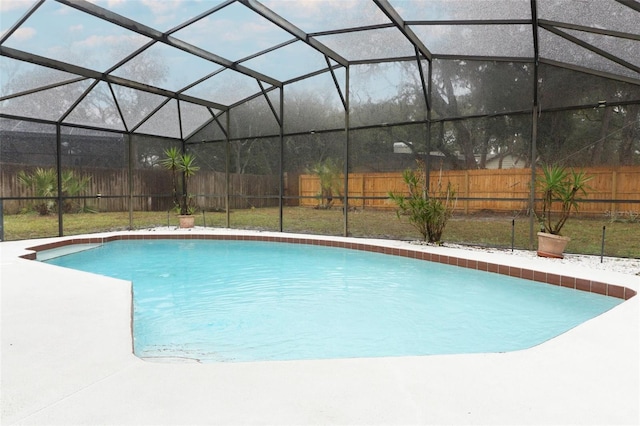 view of pool with glass enclosure